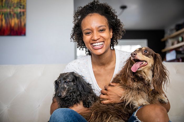 Woman hugging two dogs